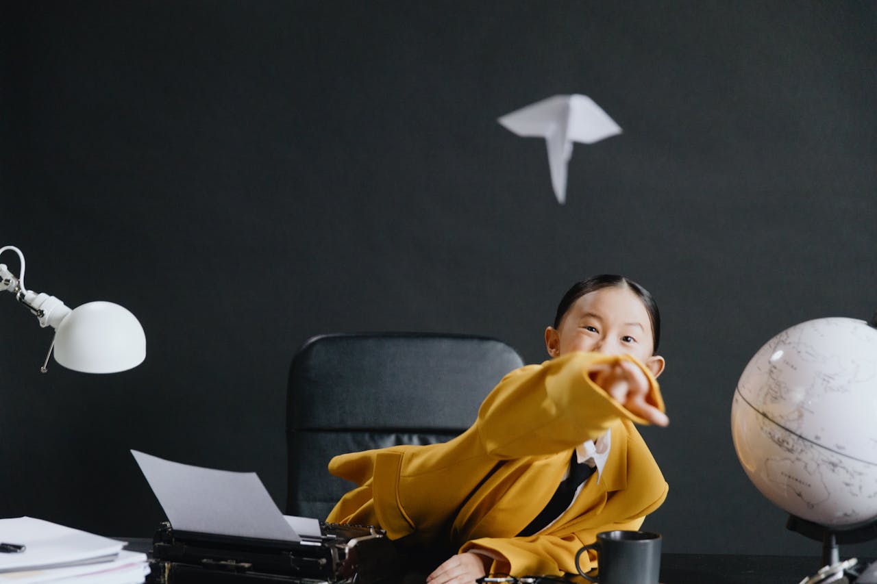 A playful scene of a young girl in an office throwing a paper airplane, featuring a globe and desk lamp.